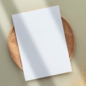 CV/Resume template cover mockup: minimal A4 paper stack flat lay on neutral background.